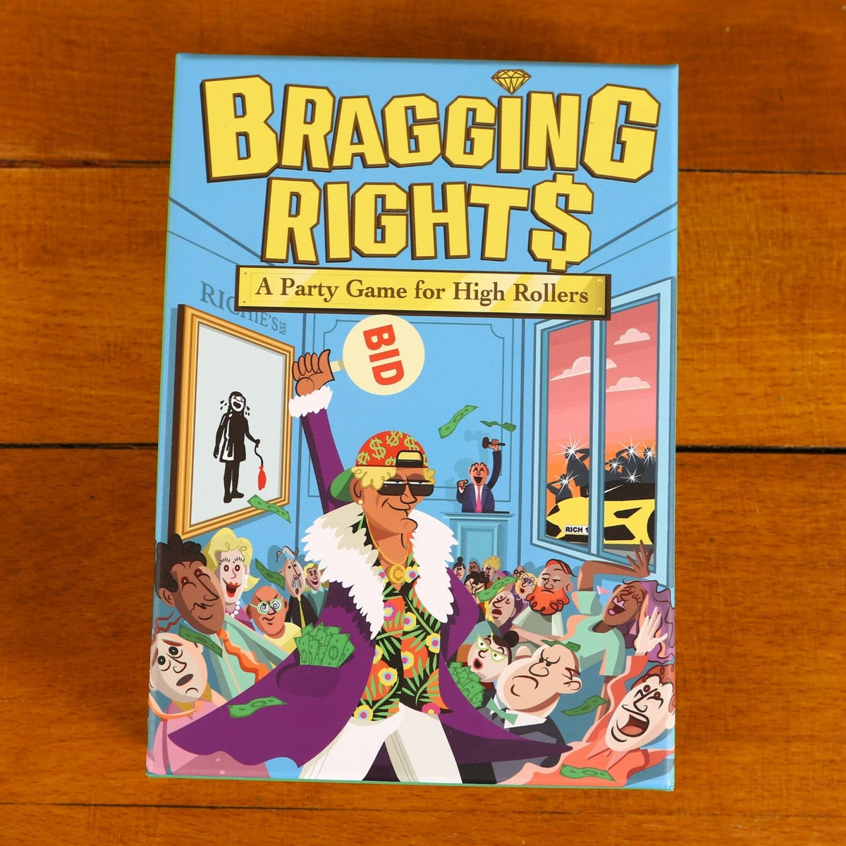 Flaunt your wealth and out-bluff your rivals! Bragging Rights is a lively jet-set party game of high-stakes auctions and shameless showmanship. Ages 10+