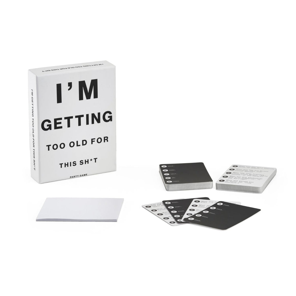 The contents of the trivia game neatly arranged, displaying the large deck of pop culture question cards and the custom scorepad.