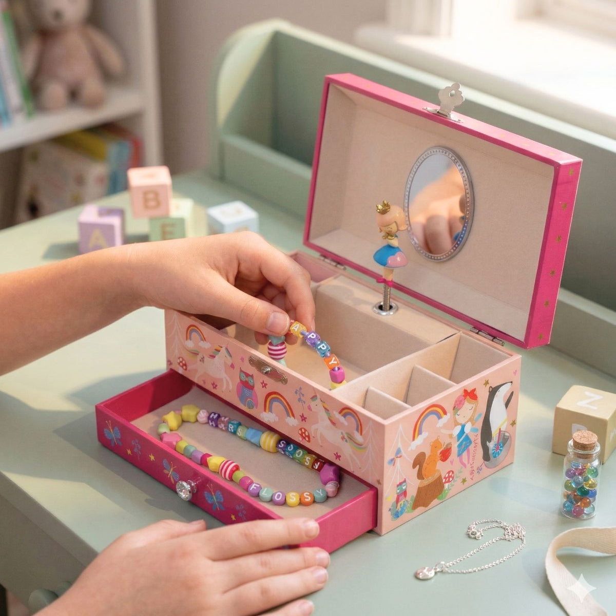 A front-facing view of the jewellery box showing the pull-out drawer partially open to store rings, bracelets, and small treasures.
