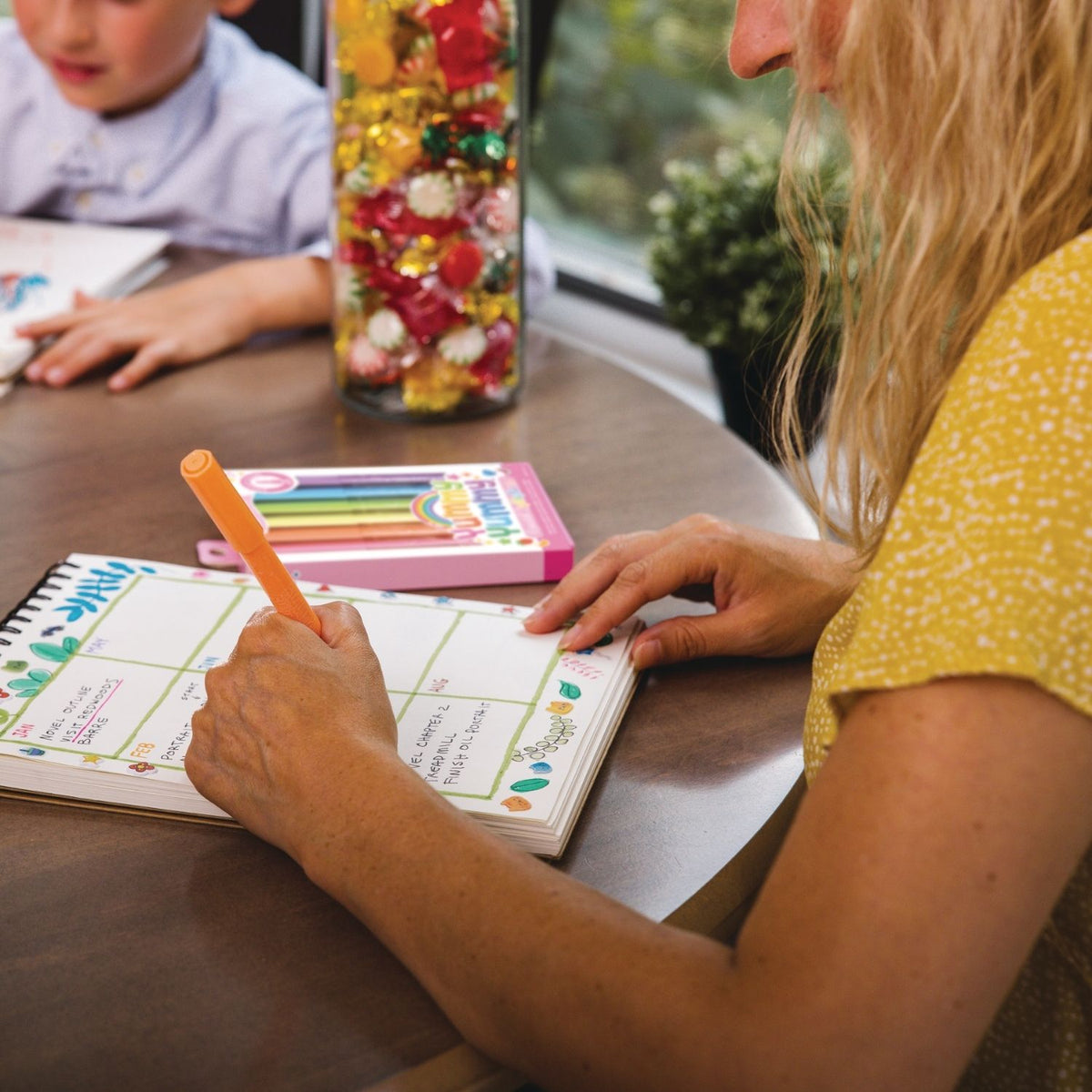 Person using a planner with the scented highlighters