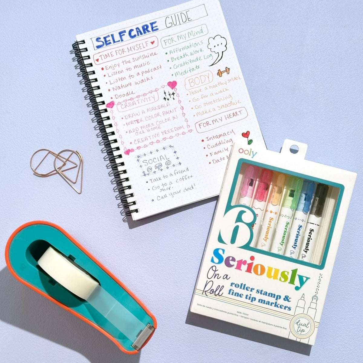 A decorated journal page featuring straight borders and colorful patterns made with a dual ended roller stamp pen.