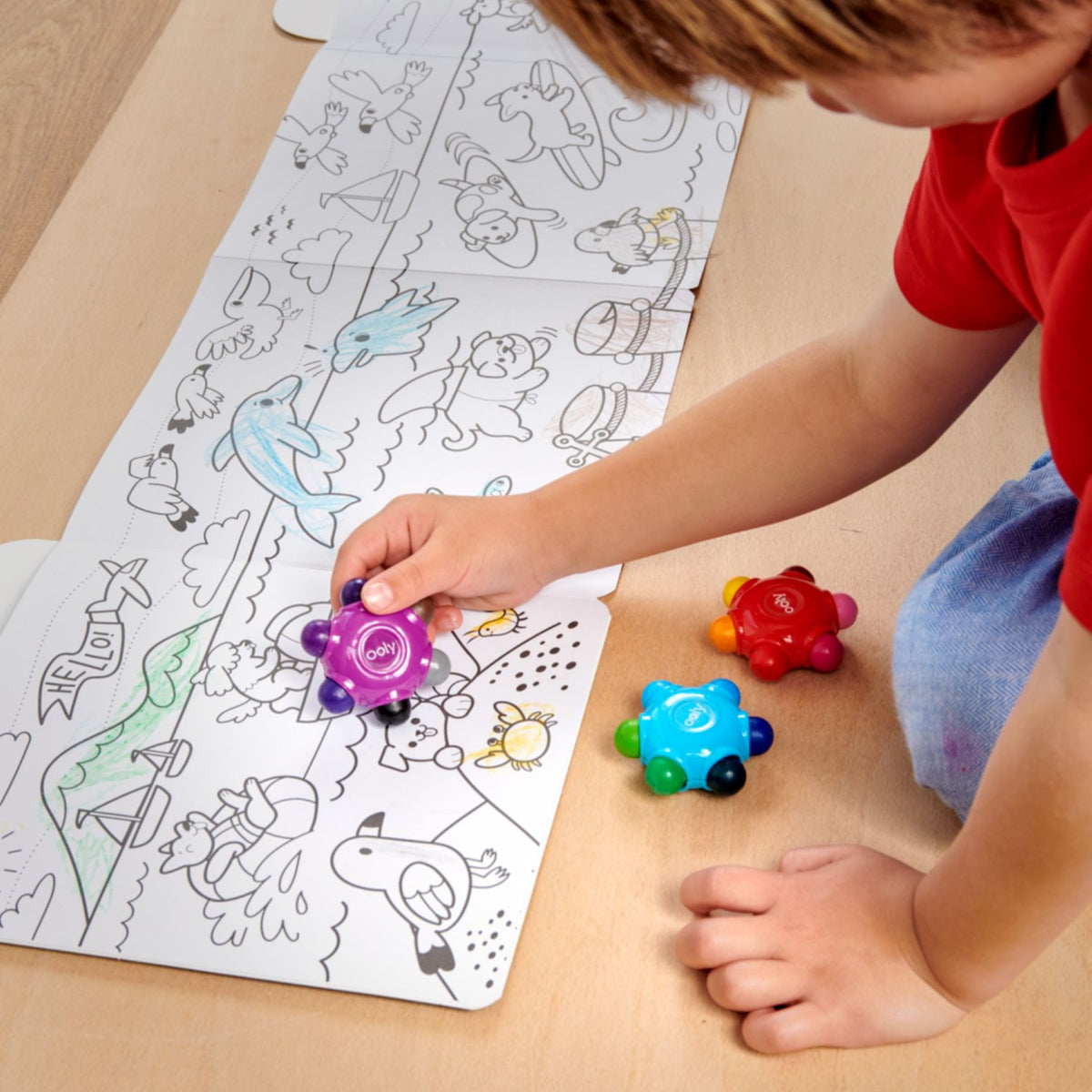 A toddler's hand comfortably grasping the chunky petal-shaped crayon, illustrating how the ergonomic design fits perfectly in a small palm.