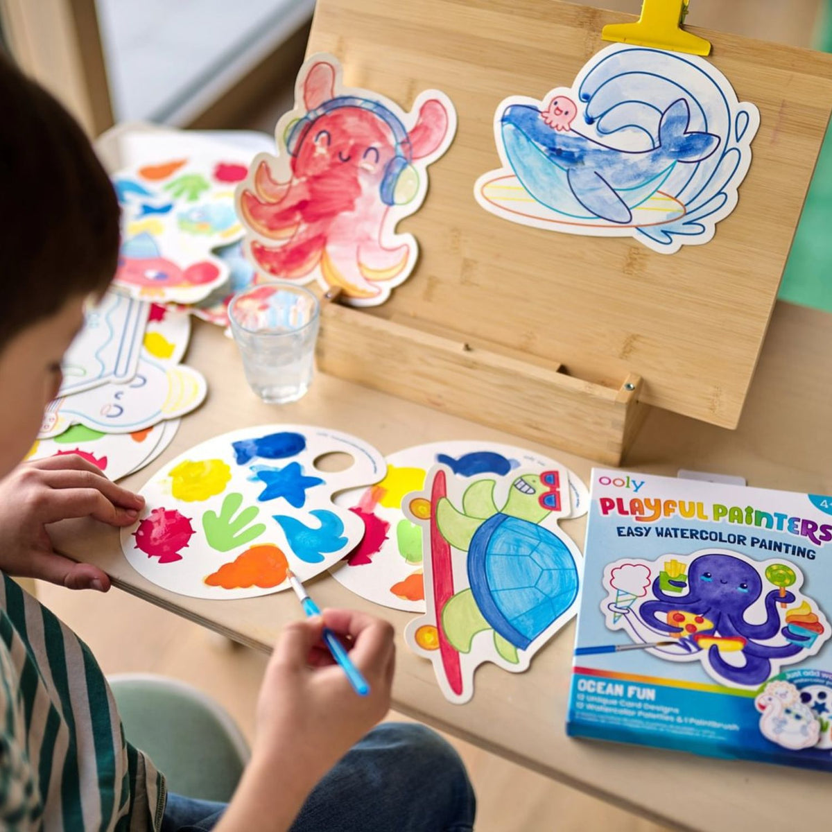Enjoy mess-free art with Ooly Playful Painters Ocean Fun! This all-in-one watercolor kit includes 12 cards with built-in palettes and a brush. Ideal for travel, gifts, and rainy days. No extra supplies needed - just add water! Perfect for ages 4+.