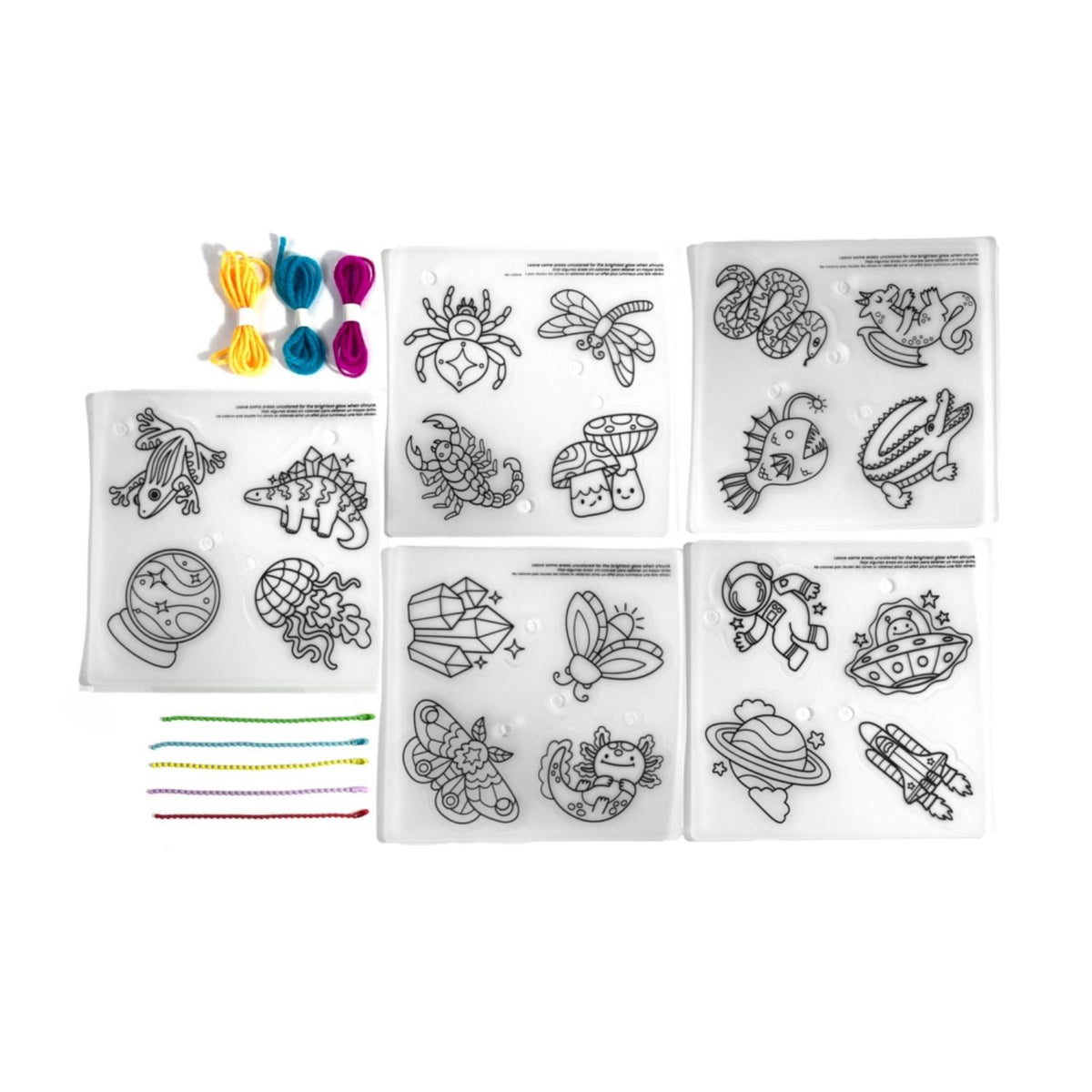 An overhead view of the complete DIY set, including 20 pre-printed glow-in-the-dark designs, coloured cords, ball chains, and instructions.