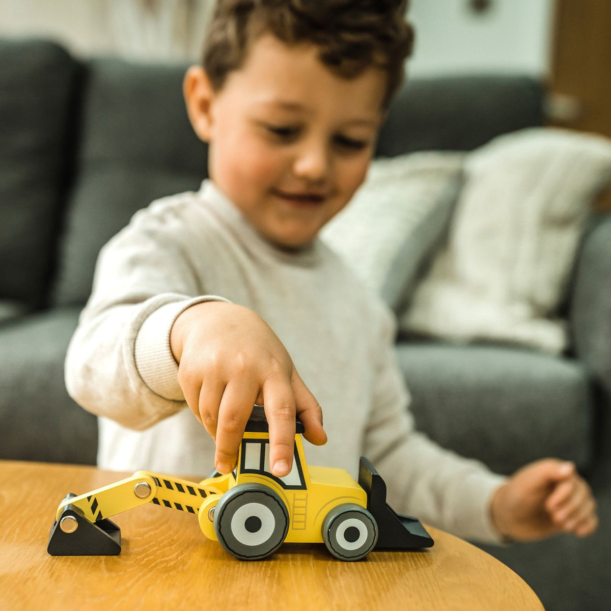 Dig, scoop, and build! The Orange Tree Toys Construction Scoop Digger Truck features a movable arm for realistic worksite fun. Builds toddler motor skills.