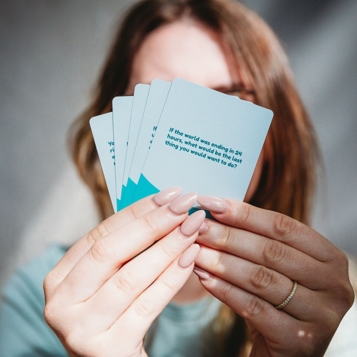 A close-up of a single prompt card, demonstrating the durable cardstock and the expert-led approach to building connection.